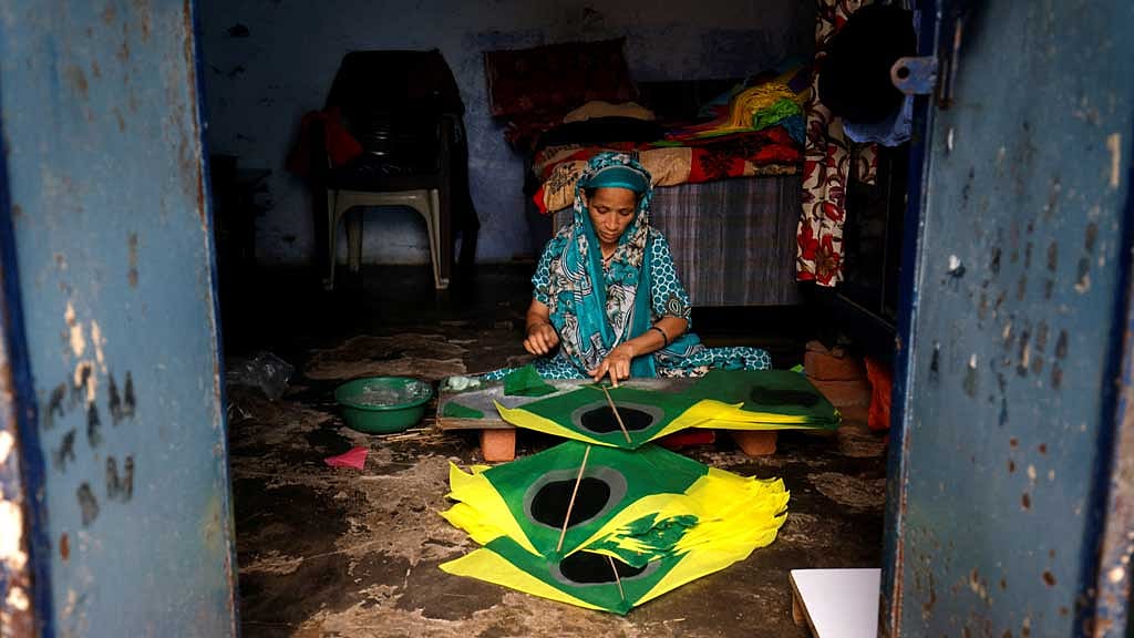 A woman makes kites inside her house in Ahmedabad, India, Oct 10, 2024. REUTERS/Amit Dave