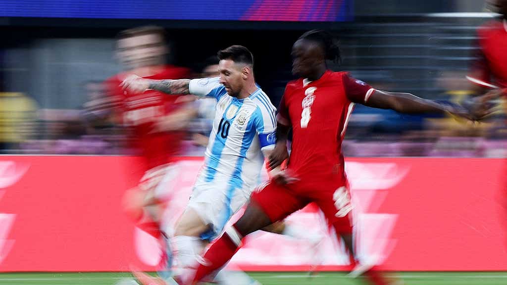 Copa America 2024 - Semi Final - Argentina v Canada - MetLife Stadium, East Rutherford, New Jersey, United States - Jul 9, 2024 Argentina's Lionel Messi in action with Canada's Cyle Larin REUTERS/Agustin Marcarian