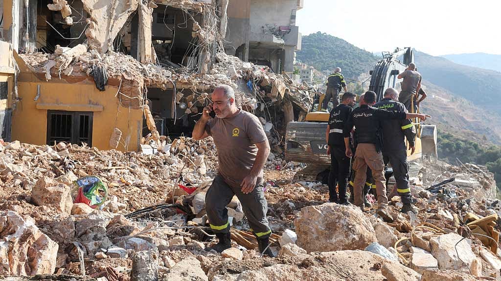 Civil defence members work at a site damaged in the aftermath of an Israeli strike, amid the ongoing hostilities between Hezbollah and Israeli forces, in Barja, Lebanon Nov 6, 2024. REUTERS/Aziz Taher