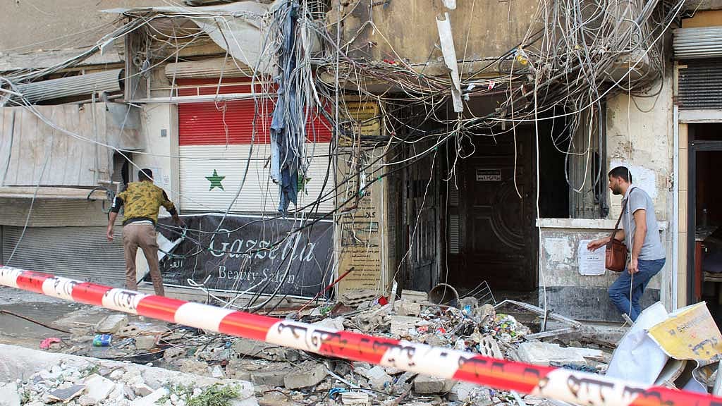 People inspect a damaged area in the aftermath of what Syrian state media reported was an Israeli strike in the Mezzah suburb, west of Damascus, Syria Oct 9, 2024. REUTERS/Firas Makdesi