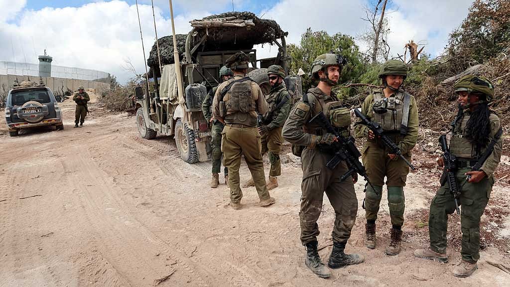 Israeli soldiers operate during an incursion and amid hostilities between Hezbollah and Israel, in southern Lebanon, Oct 13, 2024. REUTERS/Artorn Pookasook