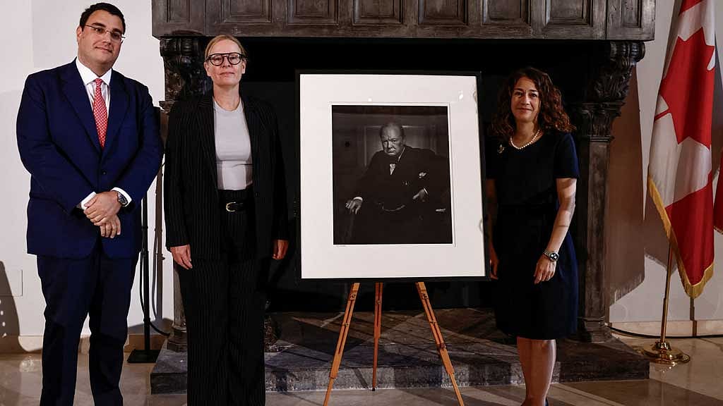 Lawyer Nicola Cassinelli, Canadian Cultural Heritage Deputy Minister Isabelle Mondou and Ambassador of Canada to Italy Elissa Golberg pose for a picture next to Yousuf Karsh's 'Roaring Lion' portrait of Churchill, stolen in 2022 from Ottawa's Fairmont Chateau Laurier and recovered in Italy, during a ceremony at the Canadian Embassy in Rome, Italy, Sept 19, 2024. REUTERS/Yara Nardi