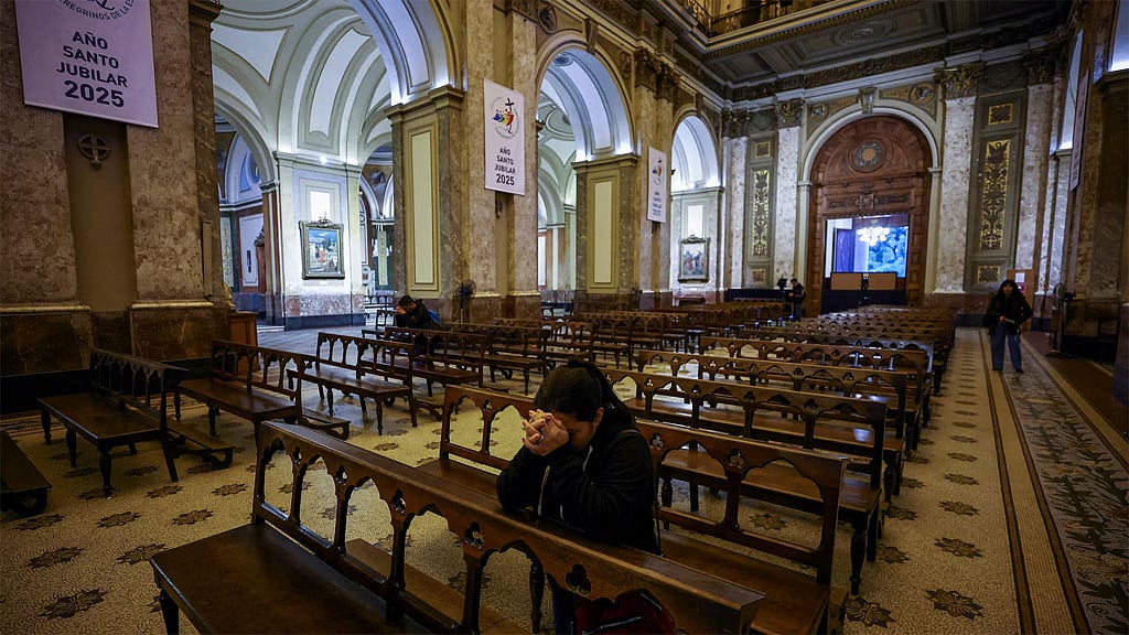 A woman prays inside Buenos Aires' Metropolitan Cathedral, after the death of Pope Francis was announced by the Vatican, in Buenos Aires, Argentina, April 21, 2025. REUTERS/Agustin Marcarian
