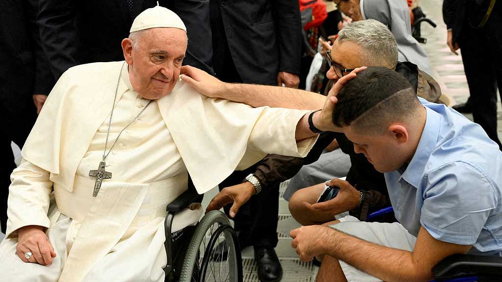 Pope Francis blesses a faithful during the weekly general audience in Paul VI hall at the Vatican, August 9, 2023. Vatican Media/­Handout via REUTERS