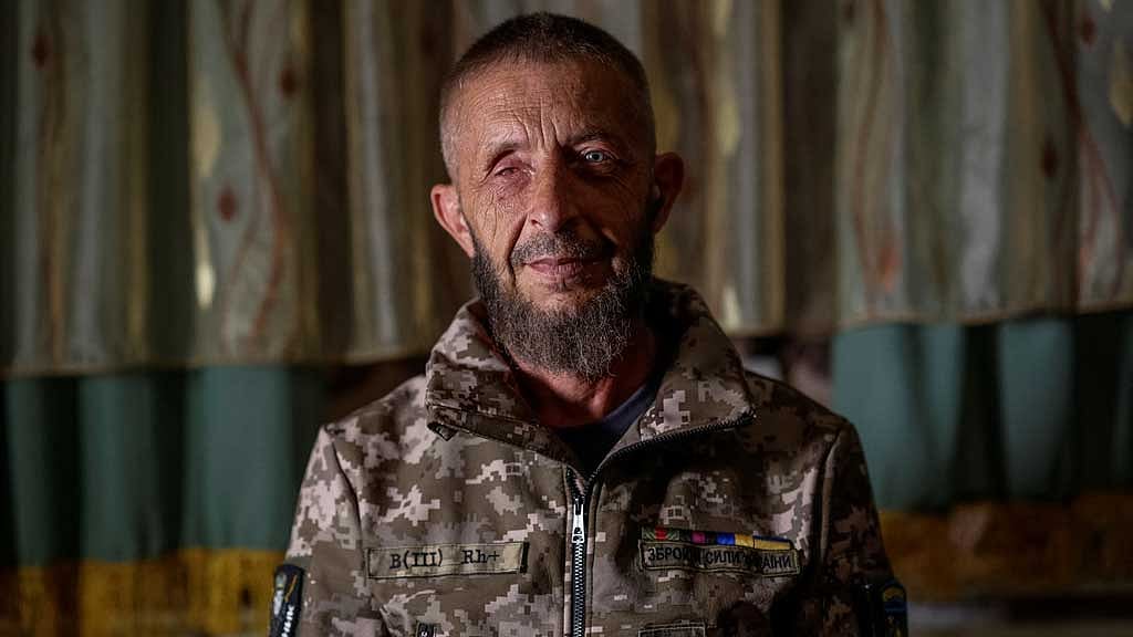  Volodymyr, 49, a wounded Ukrainian war veteran and internally displaced person (IDP) from the village of Novovodiane, near Russian-occupied Enerhodar, poses for a photo in his relative's house, where he now lives, in Zaporizhzhia, Ukraine Jun 8, 2025. REUTERS/Alina Smutko