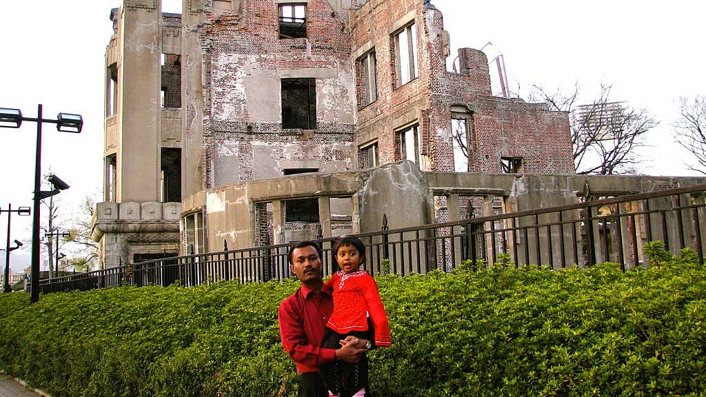 Hiroshima Peace Memorial Park, 2006. Behind the writer and his daughter, the Genbaku Dome, preserved at the blast’s epicenter. Credit: Baizid Khoorshid Riaz