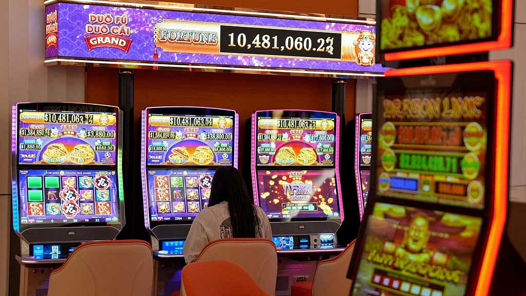  A woman plays a slot machine inside a casino at City of Dreams, an integrated resort that includes Sri Lanka's first high end casino, in Colombo, Sri Lanka, Aug 25, 2025. REUTERS