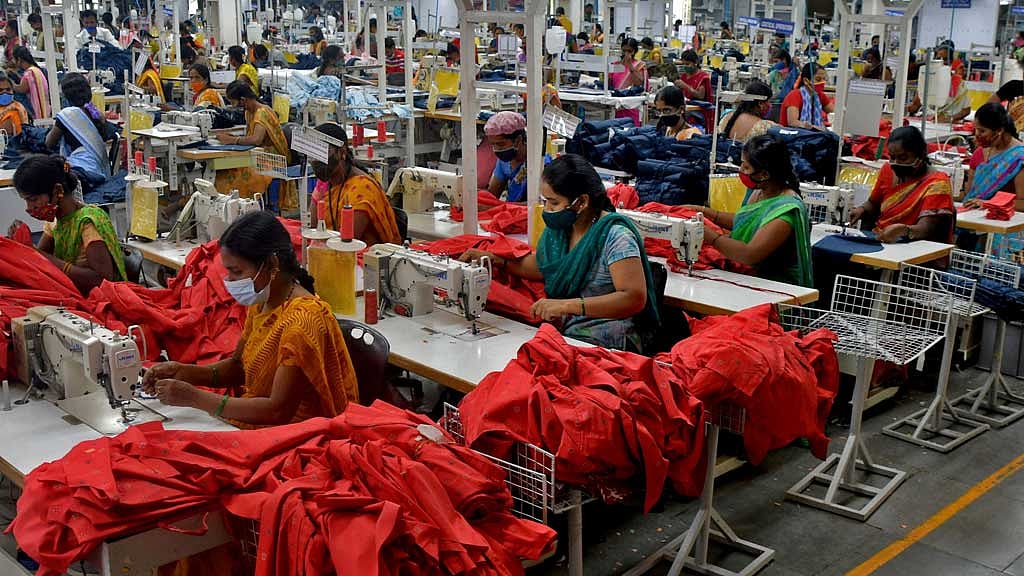 FILE PHOTO: Garment workers stitch shirts at a textile factory in Hindupur town in the southern state of Andhra Pradesh, India, Feb 9, 2022. REUTERS/Samuel Rajkumar/File Photo/File Photo