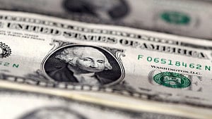 Dollar slides as Fed dents hawks