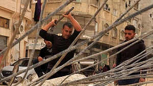 Desperate Gazans pull iron bars from rubble scratch out a living