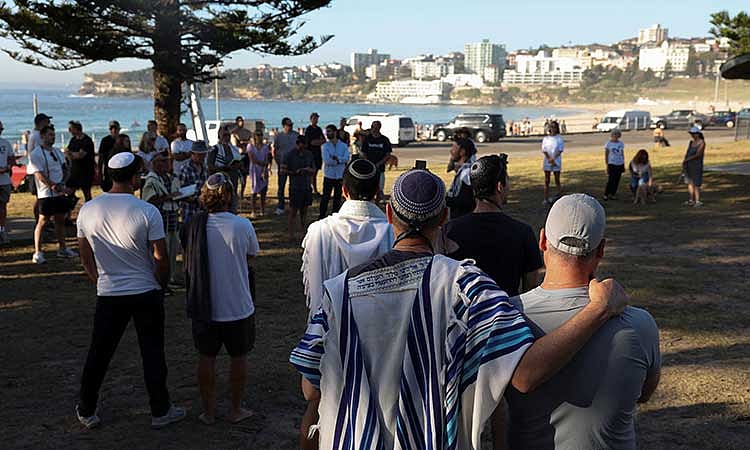 Members of the Jewish community gather for Shacharit, morning prayers, as the crime scene was reopened following the mass shooting at Bondi Beach on Sunday, in Sydney, Australia, Dec 19, 2025. REUTERS/Hollie Adams