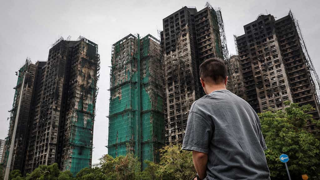 J Wong, son of Wong, a 71-year-old man whose image was captured during the deadly Wang Fuk Court fire in a widely published Reuters photograph, poses for a photo near the housing complex during an interview in Tai Po, Hong Kong, China, Nov 30, 2025. REUTERS