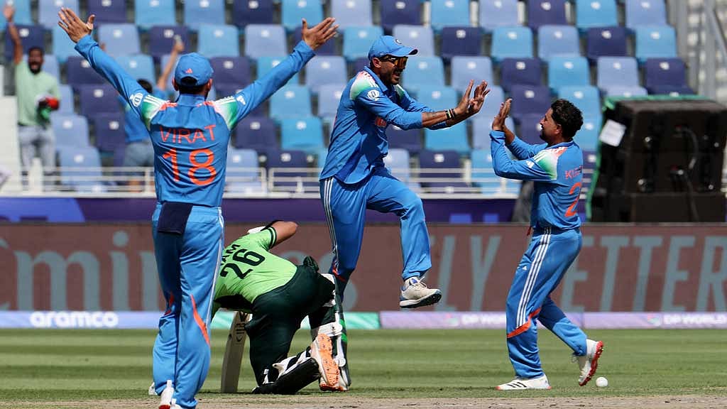 ICC Men's Champions Trophy - Group A - India v Pakistan - Dubai International Stadium, Dubai, United Arab Emirates - February 23, 2025 India's Axar Patel celebrates with Kuldeep Yadav after running out Pakistan's Imam-ul-Haq REUTERS/Satish Kumar