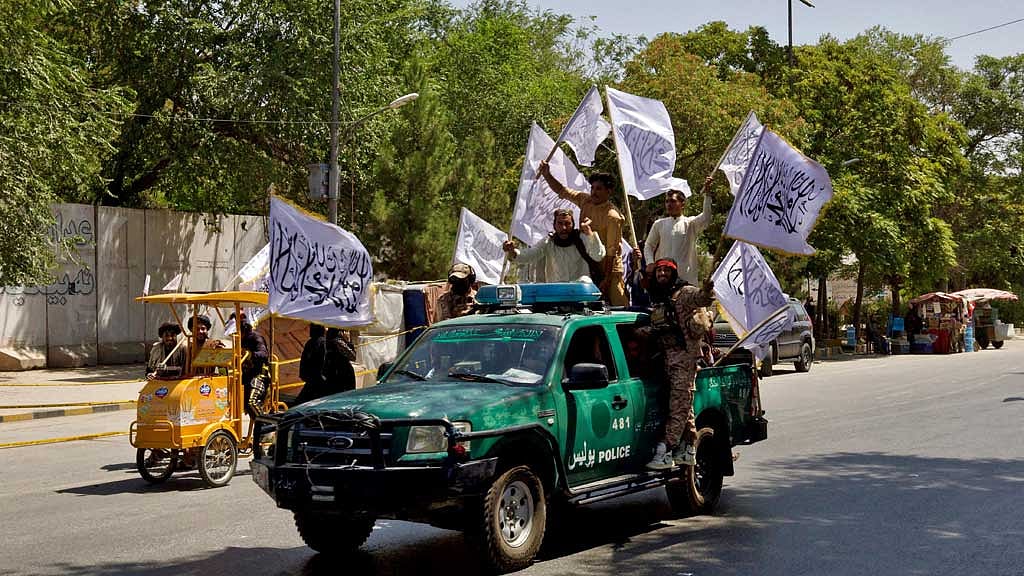 FILE PHOTO: Members of the Taliban carrying flags participate in a rally to mark the third anniversary of the fall of Kabul, in Kabul, Afghanistan, August 14, 2024. REUTERS