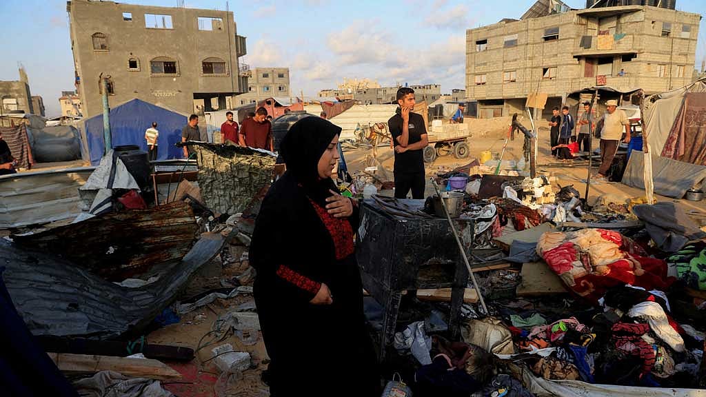 Palestinians inspect the damage at the site of an overnight Israeli air strike on a tent sheltering displaced people, in Khan Younis, southern Gaza Strip, Jul 2, 2025. REUTERS