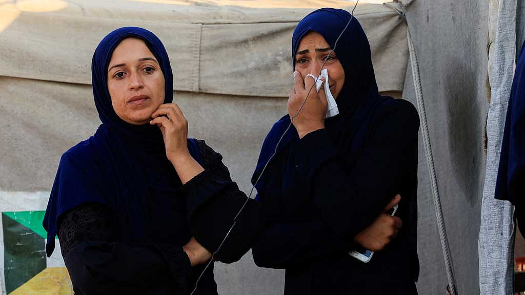 Palestinians stand near the site of an overnight Israeli air strike on a tent sheltering displaced people, in Khan Younis, southern Gaza Strip, Jul 2, 2025. REUTERS 