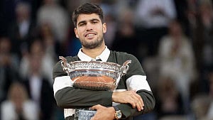 Alcaraz battles from brink to retain French Open
