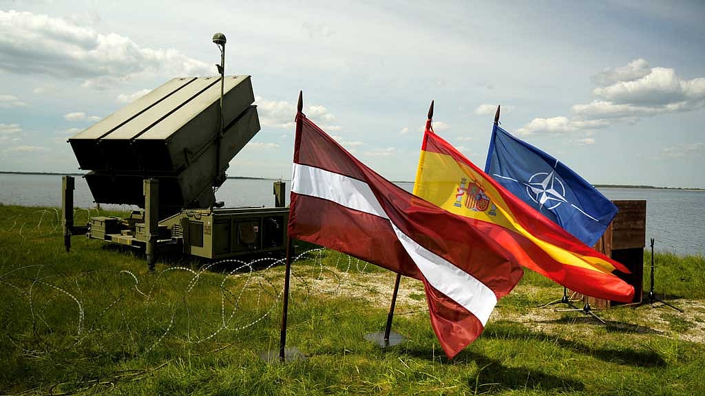 Latvian, Spanish and NATO flags flutter in front of the Spanish NASAMS air defence system, during "Latvian Shield 2025" military exercise on the bank of Riga hydroelectric power plant's water reservoir near Salaspils, Latvia May 28, 2025. REUTERS/Ints Kalnins