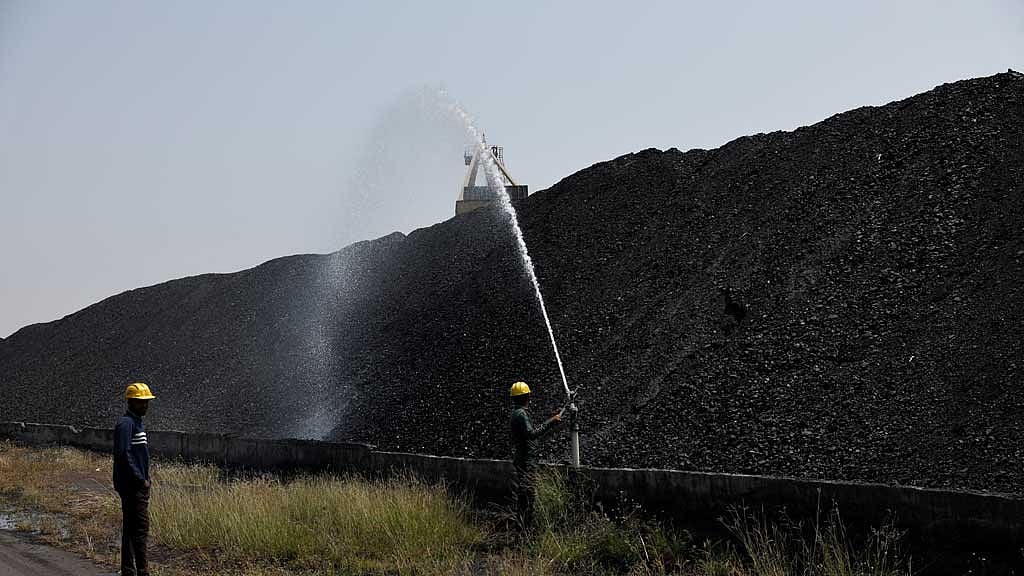 Employee's perform cooling operations where coal is stored at the NTPC (National Thermal Power Corporation) power plant in Solapur, India, March 2, 2025. REUTERS