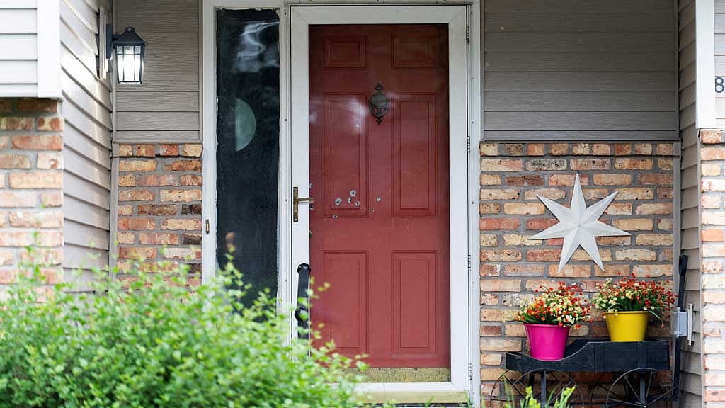 Bullet holes mark the front door of Minnesota state Senator John Hoffman, who was shot alongside his wife, Yvette, in what is believed to be an attack by 57-year-old suspect Vance Luther Boelter, who is also the lead suspect in the shooting deaths of senior Democratic state assemblywoman Melissa Hortman and her husband, Marc, in Champlin, Minnesota, US, Jun 14, 2025. REUTERS/Tim Evans