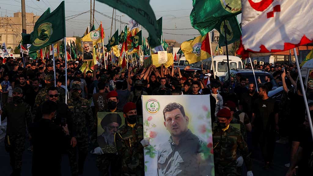 Mourners attend the funeral of Haider al-Moussawi, head of the security unit in the Shi'ite armed group Kataib Sayyid al-Shuhada, and senior Hezbollah figure Abu Ali Khalil, who were killed in an Israeli airstrike on Tehran, amid the Iran-Israel conflict, in Baghdad, Iraq, Jun 22, 2025. REUTERS