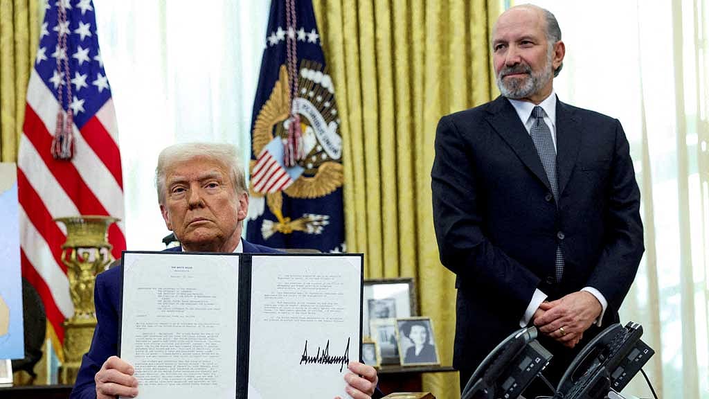  US President Donald Trump holds an executive order about tariffs increase, flanked by US Commerce Secretary Howard Lutnick, in the Oval Office of the White House in Washington, DC, US, Feb 13, 2025. REUTERS/File Photo