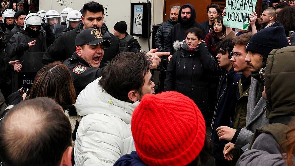 Police officer gestures as university students take part in a protest against the detention of Istanbul Mayor Ekrem Imamoglu, in Istanbul, Turkey, Mar 20, 2025. REUTERS/Umit Bektas