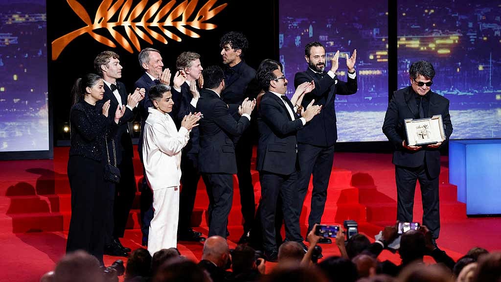 Director Jafar Panahi, Palme d'Or award winner for the film "Un simple accident" (It Was Just an Accident), poses with award next to a team of the film on stage, during the closing ceremony of the 78th Cannes Film Festival in Cannes, France, May 24, 2025. REUTERS/Benoit Tessier