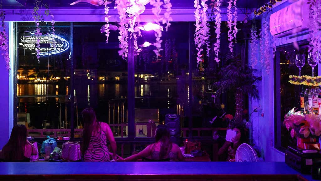 Women sit inside a waterfront bar in Koror, Palau, April 12, 2025. REUTERS