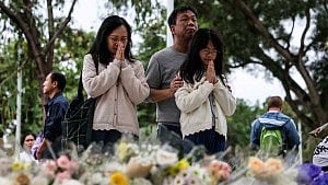 Mourners flock to site of Hong Kong blaze as China warns against protests