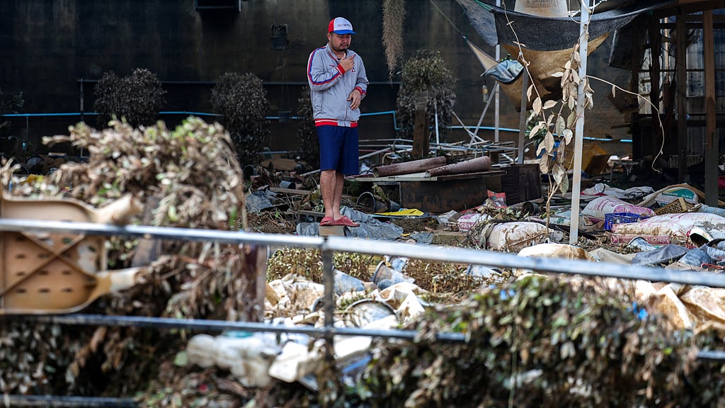 A man stands amid debris in a flooded area in Hat Yai district, Songkhla province, Thailand, Nov 28, 2025. REUTERS/Athit Perawongmetha