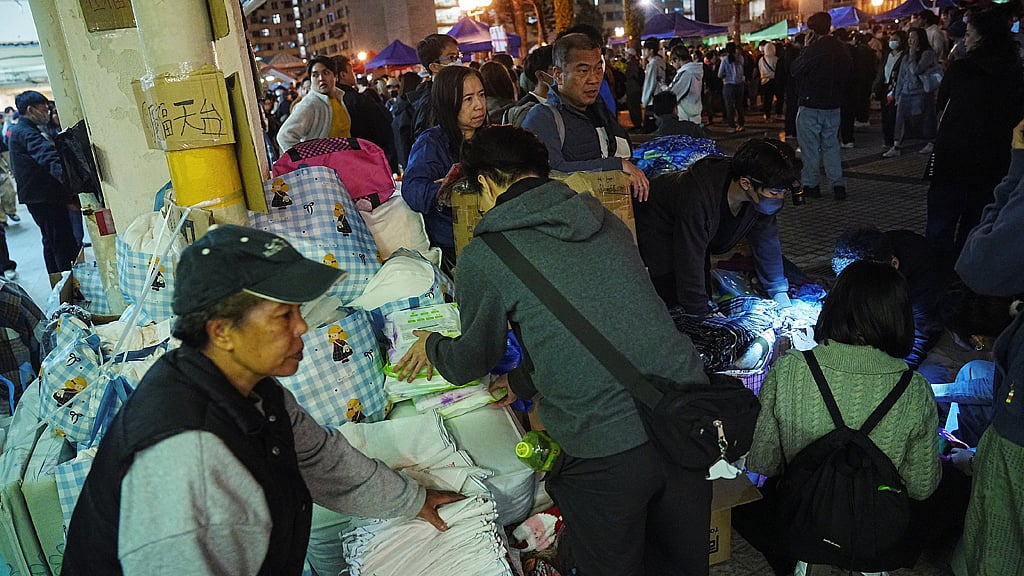 People distribute supplies at a volunteer camp, after a deadly fire at the Wang Fuk Court housing complex, in Hong Kong, China November 28, 2025. REUTERS