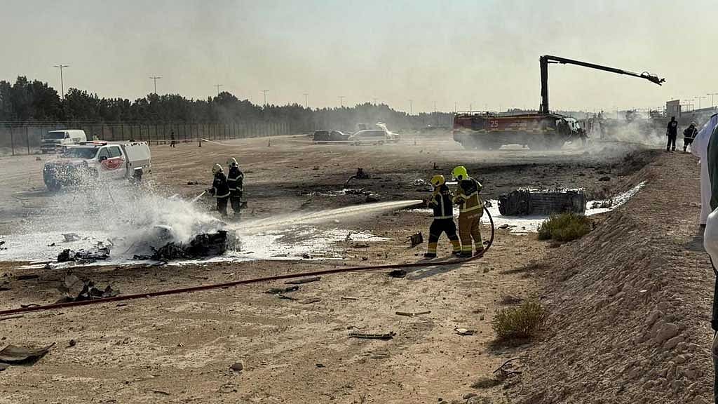 Firefighters work at the site of a crash involving an Indian-made HAL Tejas fighter jet at the Dubai Air Show, United Arab Emirates, November 21, 2025, in this handout picture obtained from social media. Government of Dubai Media Office/Handout via REUTERS 