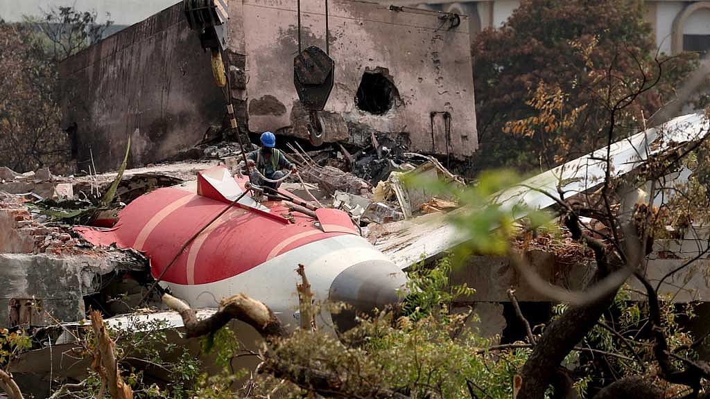 A man prepares to remove the wreckage of the Air India Boeing 787-8 Dreamliner aircraft, which crashed during take-off from an airport, in Ahmedabad, India June 14, 2025. REUTERS