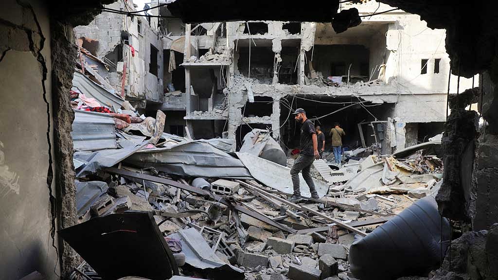 Palestinians inspect the site of an Israeli strike on Saturday, on a house in the Tuffah neighbourhood in Gaza City Oct 5, 2025. REUTERS