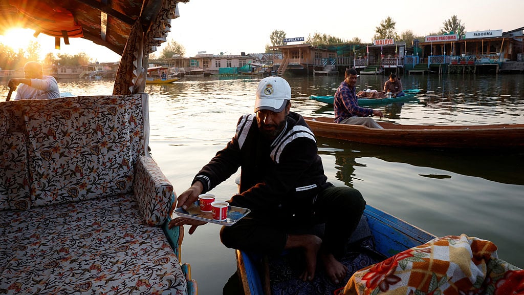 Gulzar Ahmad Bhat, 49, a carpet weaver, sells tea on the waters of Dal Lake in Srinagar, Indian Kashmir, Oct 14, 2025. REUTERS/Sharafat Ali