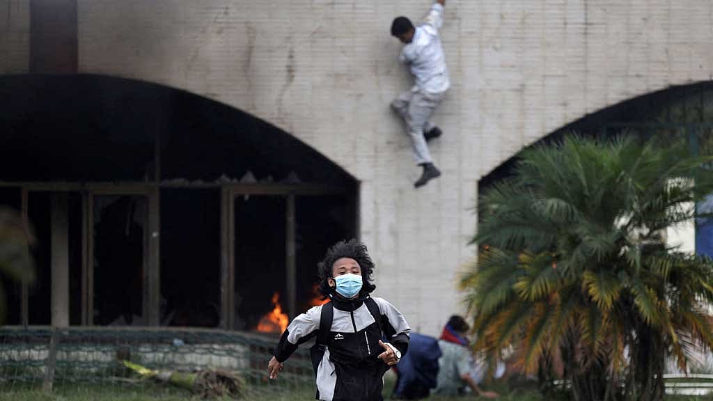 A demonstrators runs for cover as they are chased away by police jumps during a protest against corruption and the government’s decision to block several social media platforms, in Kathmandu, Nepal, Sept 8, 2025. REUTERS/Navesh Chitrakar