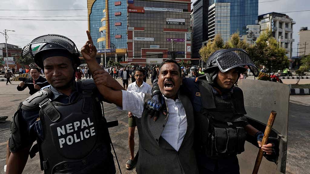 A demonstrator reacts as he is detained by police officers outside the Parliament during a curfew following a protest against corruption and government’s decision to block several social media platforms, in Kathmandu, Nepal, Sept 9, 2025. REUTERS/Navesh Chitrakar 
