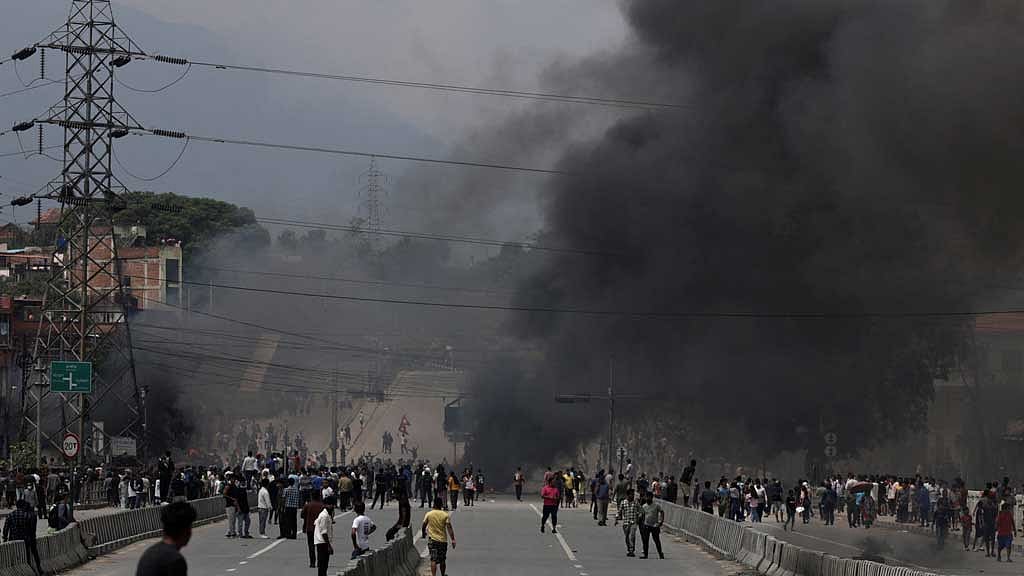 Smoke rises as demonstrators gather to protest against Monday's killing of 19 people after anti-corruption protests that were triggered by a social media ban which was later lifted, during a curfew in Kathmandu, Nepal, Sept 9, 2025. REUTERS/Navesh Chitrakar
