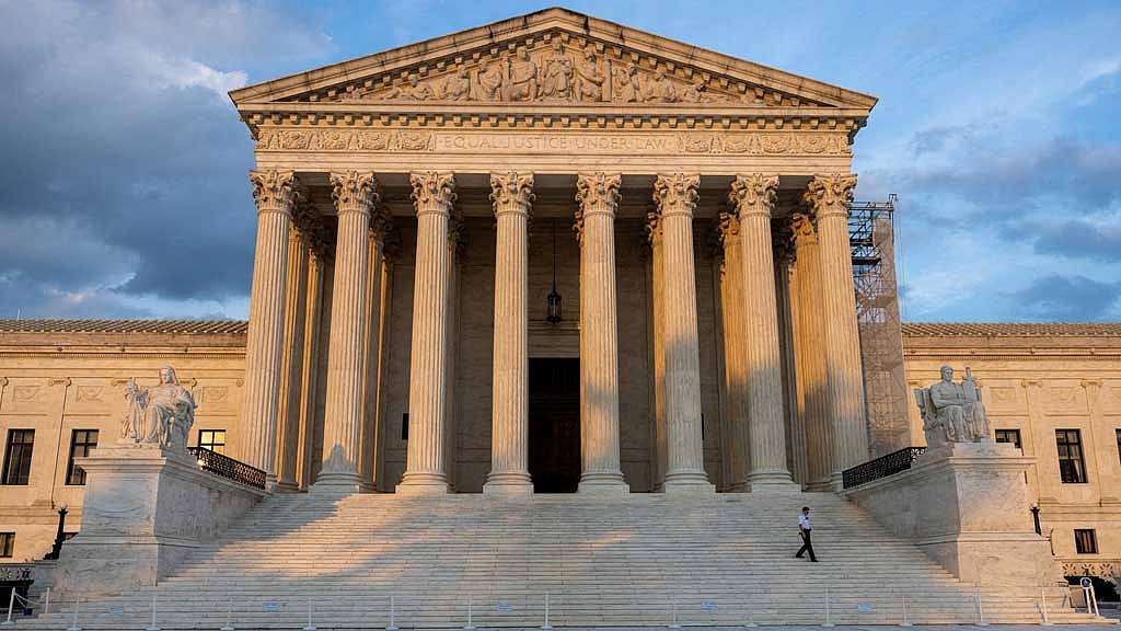 FILE PHOTO: A security guard walks down the steps of the US Supreme Court in Washington, US, Jul 19, 2024. REUTERS/Kevin Mohatt/File Photo