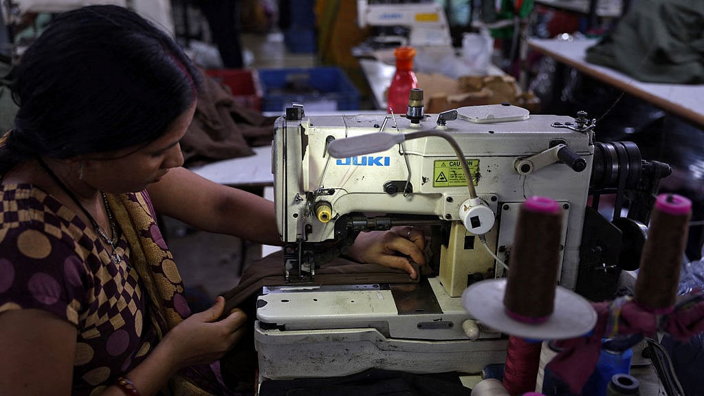 An employees stitches polyester fabric inside the readymade garment manufacturing department of Bindal Silk Mills in Surat, Gujarat, India, Apr 16, 2026. REUTERS/Amit Dave