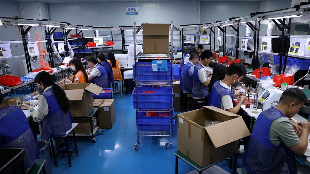 Employees work on a production line manufacturing electronic products at a factory of Agilian Technology, in Dongguan, Guangdong province, China Mar 16, 2026. REUTERS