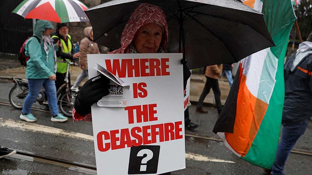 A demonstrator holds a placard in support of Palestinians during a protest in relation to the ceasefire in Gaza, in Dublin, Ireland, Feb 21, 2026. REUTERS/Clodagh Kilcoyne