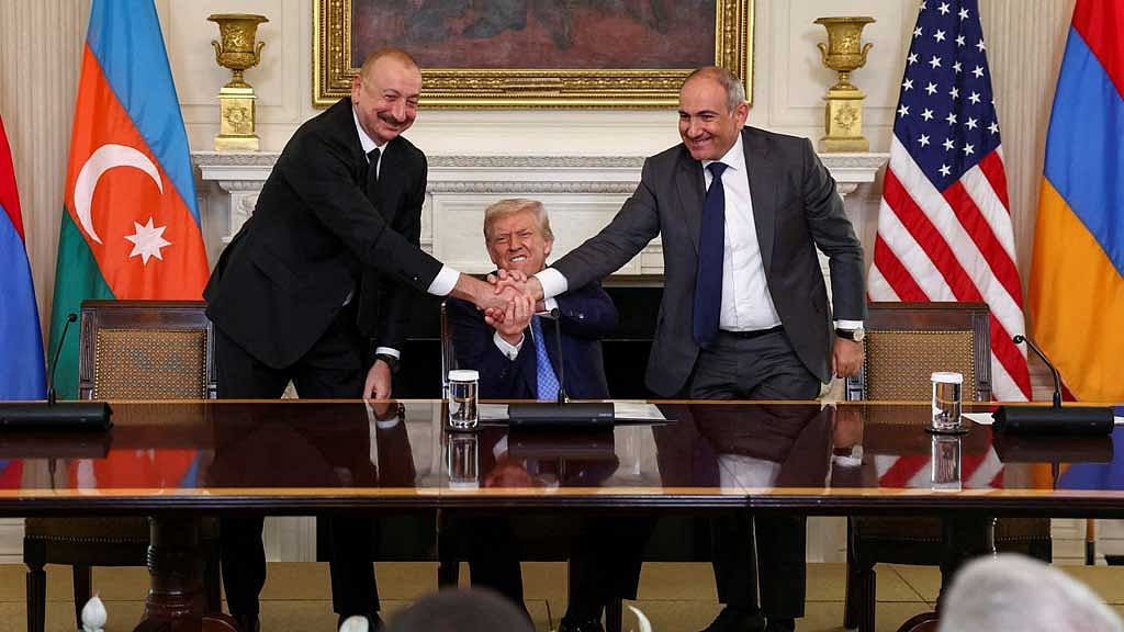 FILE PHOTO: US President Donald Trump holds the hands of Azerbaijan's President Ilham Aliyev and Armenia's Prime Minister Nikol Pashinyan as they shake hands between each other during a trilateral signing event, at the White House, in Washington, DC, Aug 8, 2025. REUTERS/Kevin Lamarque/File Photo