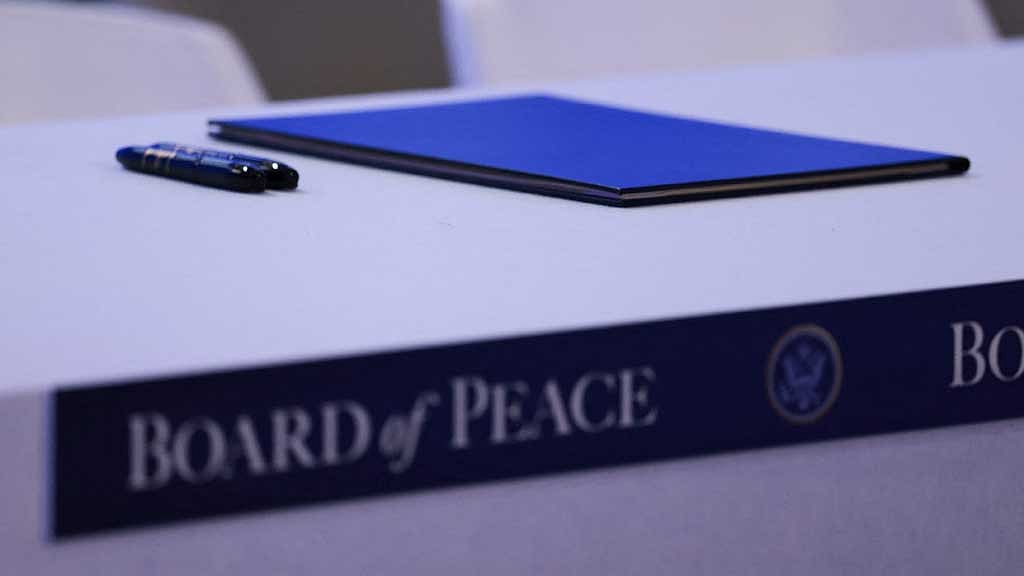 Pens and documents in the conference room, ahead of a charter announcement for US President Donald Trump's Board of Peace initiative aimed at resolving global conflicts, alongside the 56th annual World Economic Forum (WEF), in Davos, Switzerland, Jan 22, 2026. REUTERS/Jonathan Ernst