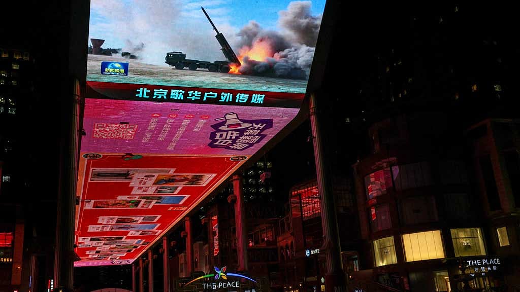 A giant screen shows a news report on China's "Justice Mission 2025" military drills around Taiwan, in Beijing, China December 30, 2025. REUTERS