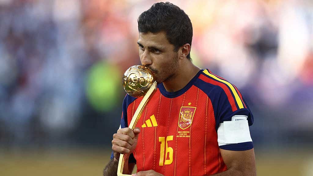 Spain’s midfield anchor Rodri kisses the Golden Ball trophy—a decision that triggered global outrage after he scooped the award despite posting zero goals and zero assists. (Photo: Reuters/Lee Smith)