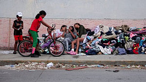 Families search for US deportee Venezuelans lost in hotel collapse