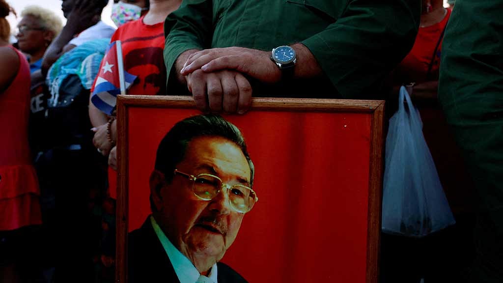 A person holds a picture of former Cuban president Raul Castro, as people gather ahead of a pro-government rally called by Cuban authorities to protest US policies toward the island, including the indictment of Castro, in Havana, Cuba, May 22, 2026. REUTERS/Norlys Perez