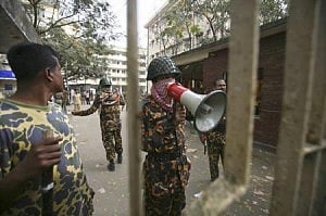 A mutinous soldier of the then Bangladesh Rifles (BDR) uses a loudhailer to speak to the media at their headquarters in Dhaka February 26, 2009. Photo: Reuters  